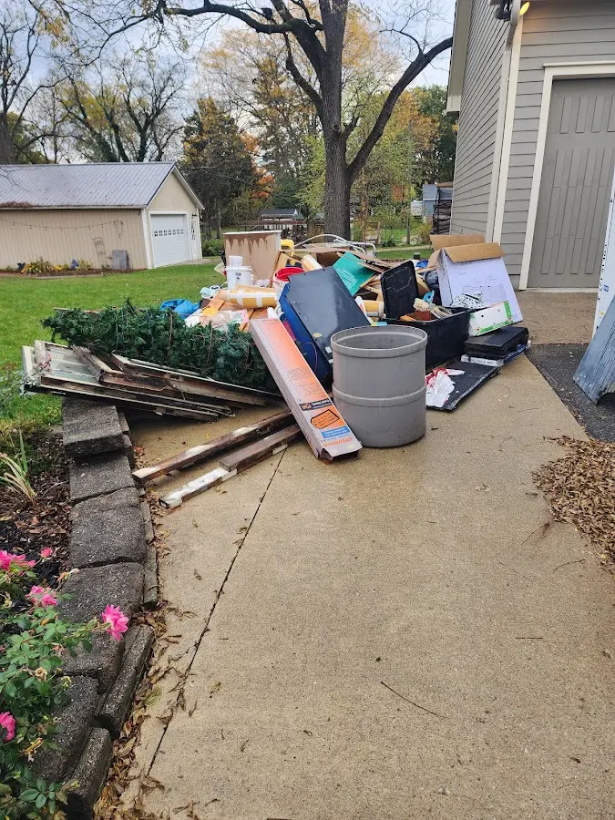 Dumpster being loaded with debris for Estate Cleanout Dumpster Rental in Fruitland